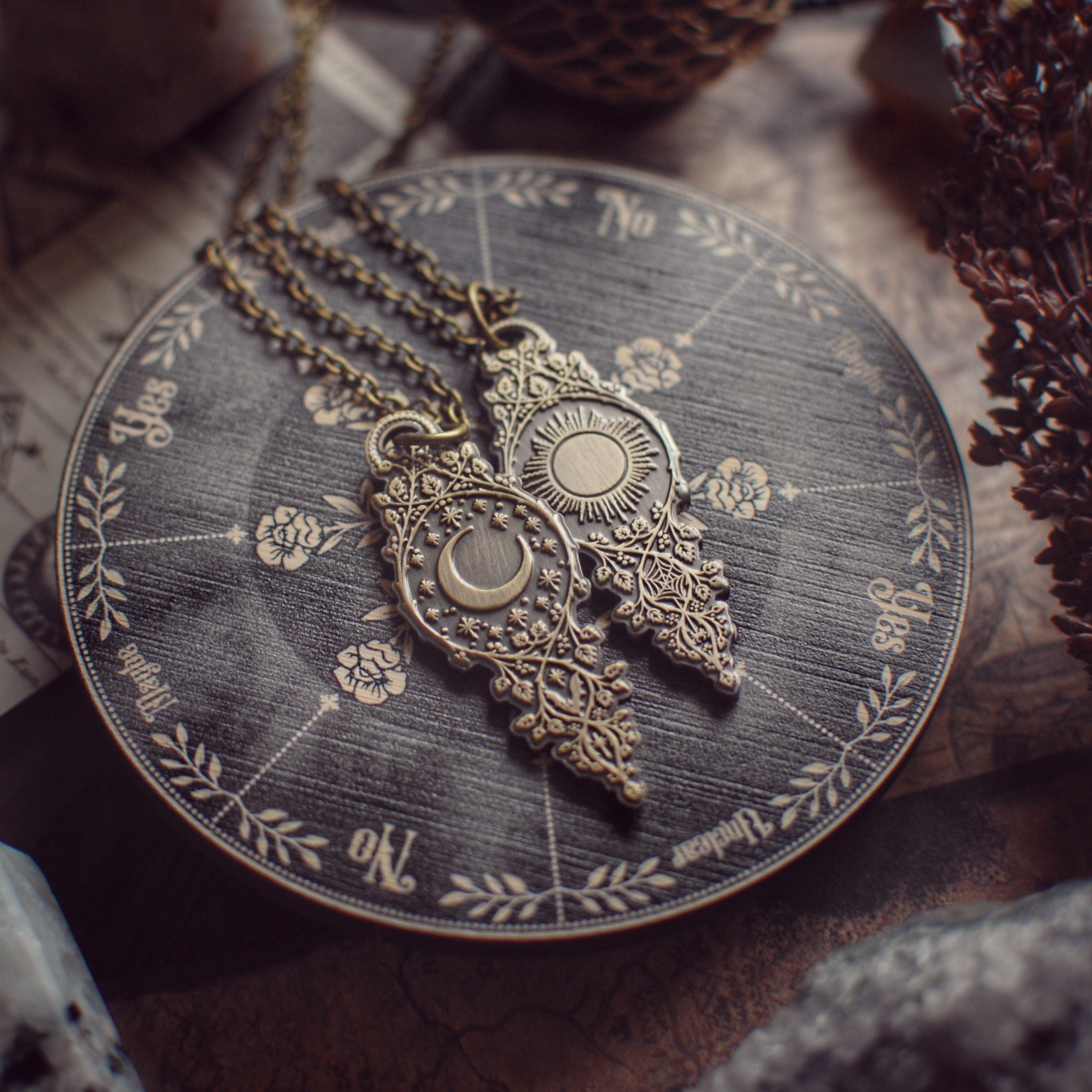 Decorative pendulum on a circular pendulum board with engraved designs, placed on a bamboo surface.