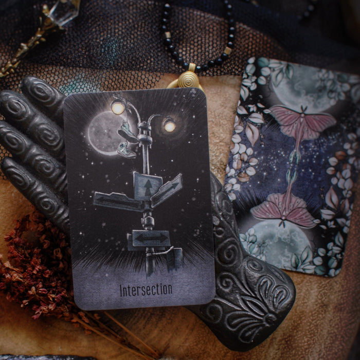 Card with 'Intersection' design surrounded by mystical items on a textured surface