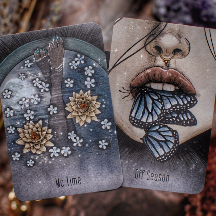 Two tarot cards with artistic designs on a natural background