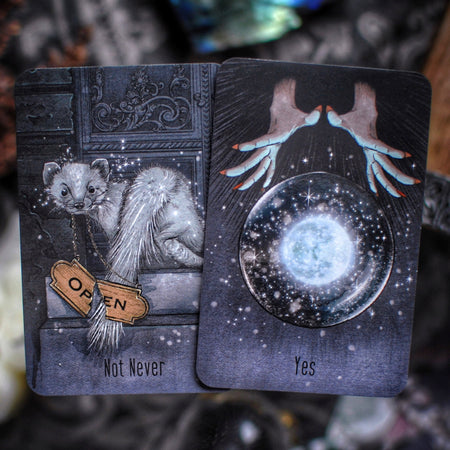 Two tarot cards with mystical illustrations and text on a blurred background
