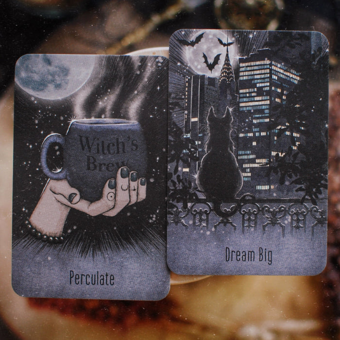 Two tarot cards with illustrations and text on a textured surface
